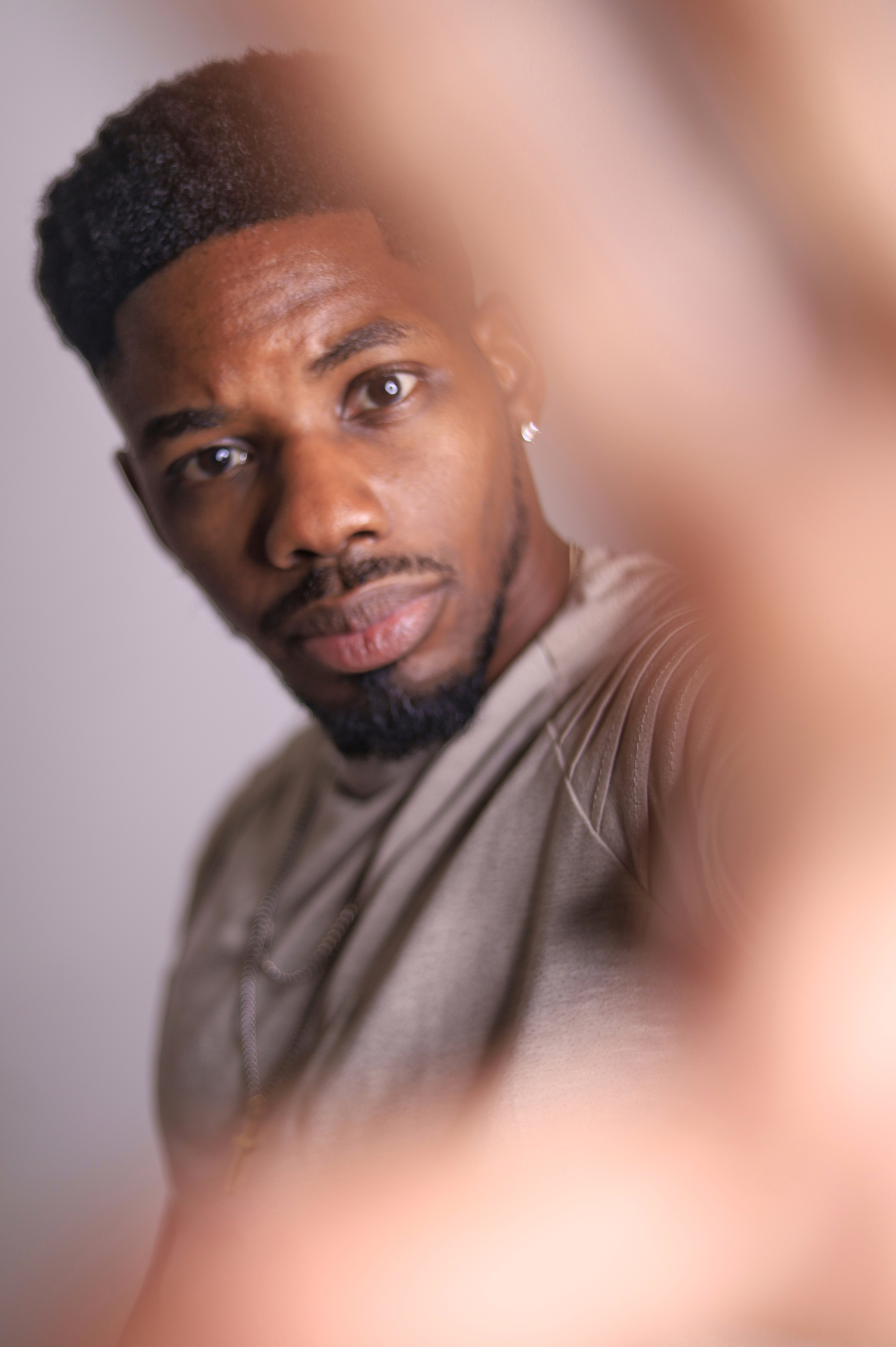 Close-up portrait of Jimmie Miller reaching toward the camera