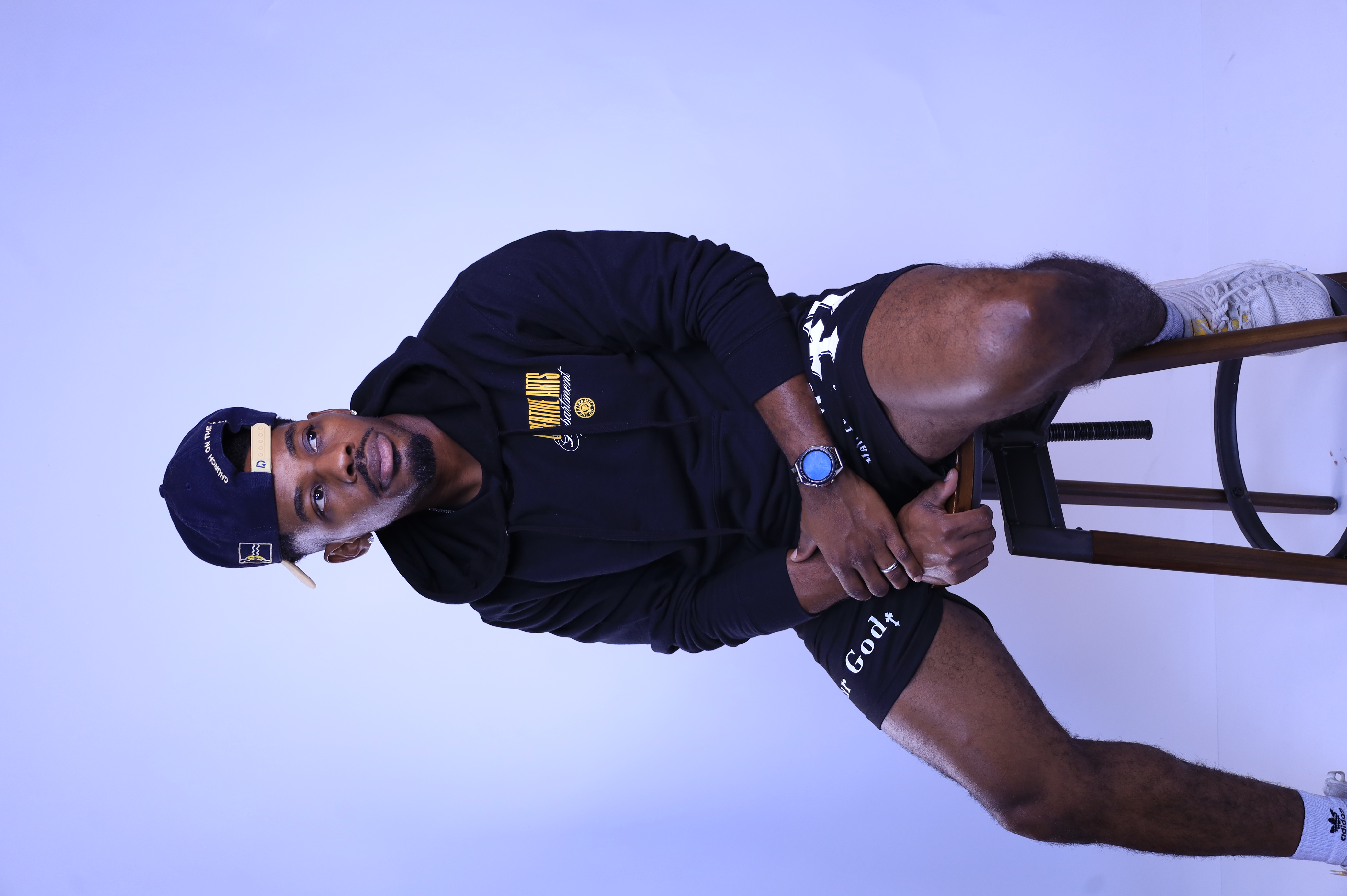 Jimmie Miller seated in a hoodie and cap